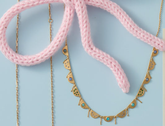 Gold scalloped necklace with opals, sapphires and garnets.