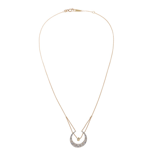 Selene Diamond Crescent Moon Necklace by Unhada. The Selene Diamond Moon Necklace is aptly named after the Greek goddess and features a sterling silver pendant encrusted with .34 cts of diamonds, complemented by blue sapphires and faceted rainbow moonstones. Adding to its elegance, a single pear-cut labradorite rests at the center of the crescent, suspended from an 18k yellow gold chain. The necklace can be adjusted to a length of 16 - 18" making it perfect for layering with other pieces.