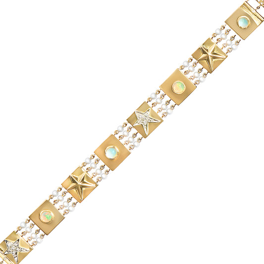 A future heirloom, the one-of-a-kind Capture Bracelet is a testament to extraordinary craftsmanship. Strands of luminous pearls frame a series of 18k gold tiles, each adorned with intricate details: pavé diamond stars (.09 cts), glowing opals, serene aquamarines, and sculpted convex stars. The interplay of textures and gemstones creates a design that feels timeless yet utterly unique. At 6.5” with an adjustable fit, this bracelet is more than a piece of jewelry—it’s a work of art destined to be cherished fo