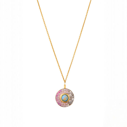 The Pink Sapphire Mirror Necklace is a study in soft radiance, blending color and light with effortless grace. At its center, an Australian opal reflects shifting hues, surrounded by pavé ombré pink sapphires (.43 cts) and diamonds (.24 cts) that deepen and fade like a whispered secret. Set in a mix of 18k gold and silver, the pendant floats on an adjustable 16–17” chain, it’s a piece that feels both modern and timeless—whether layered or worn on its own.